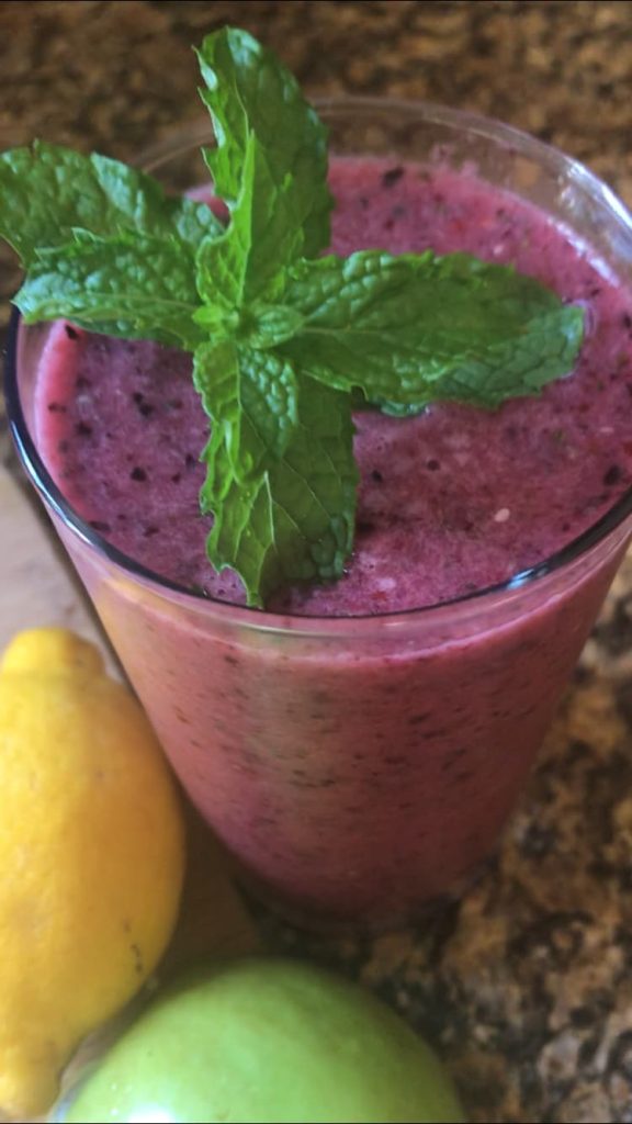 Berry detox smoothie with fresh mint, lemon, and green apple for natural nutrition support